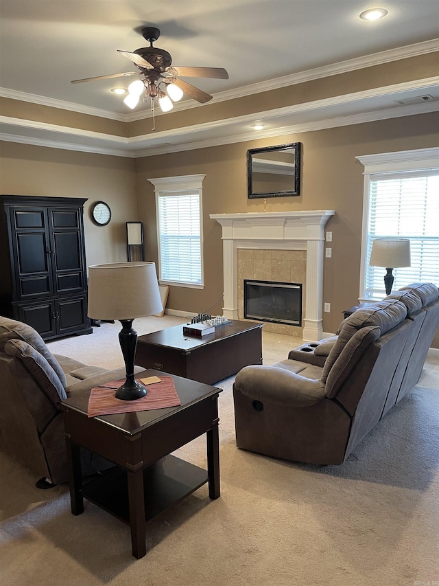 living room featuring a fireplace, light colored carpet, and crown molding
