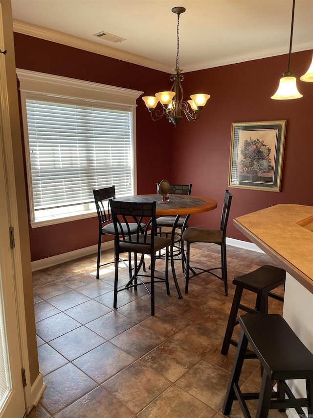 dining room featuring a chandelier, visible vents, baseboards, and crown molding