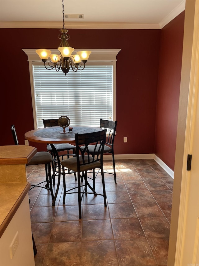 dining room featuring a chandelier, visible vents, baseboards, and crown molding