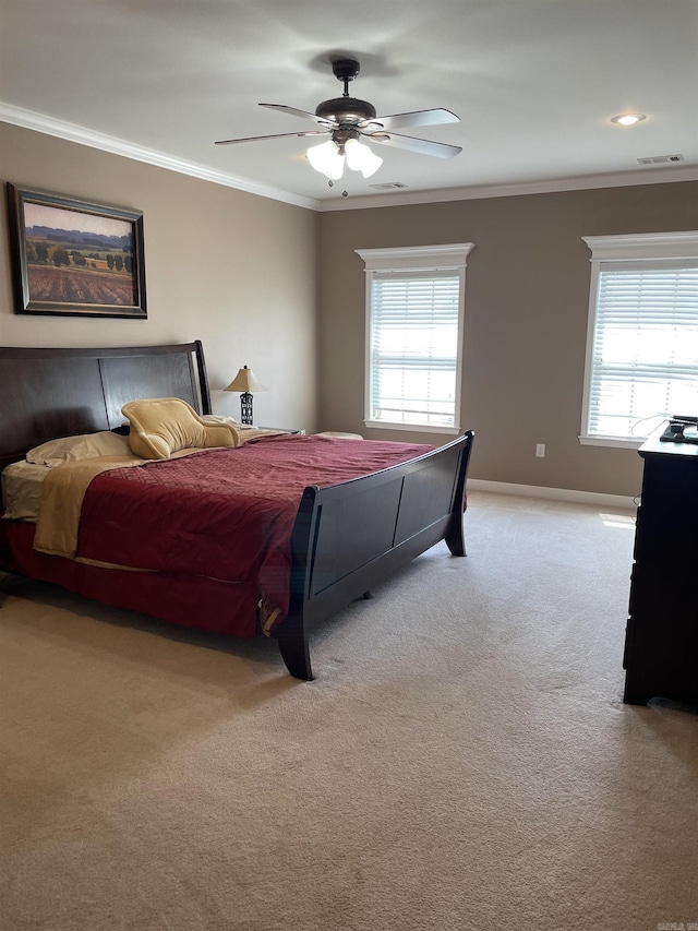 bedroom with ornamental molding, visible vents, multiple windows, and light colored carpet