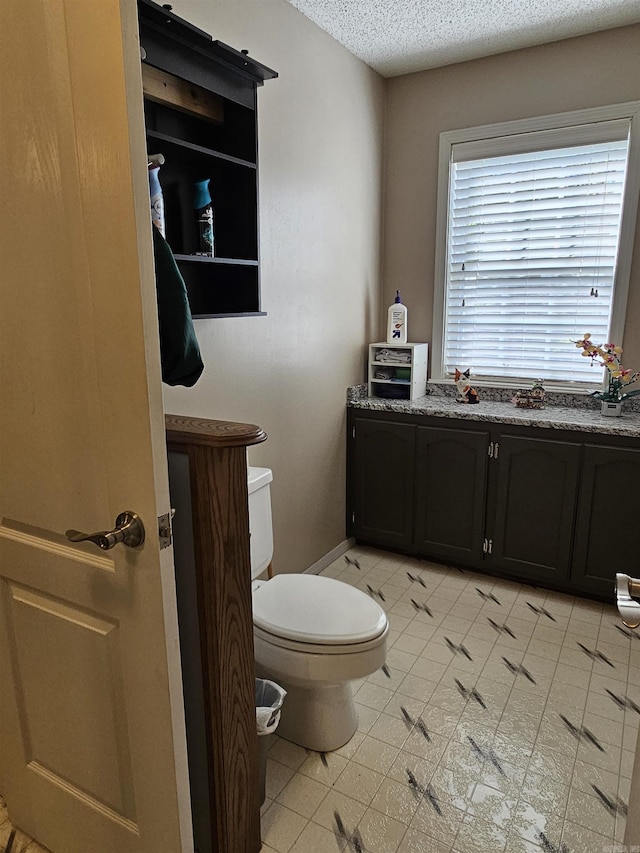 bathroom featuring toilet and a textured ceiling