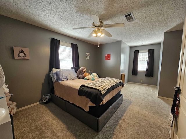 bedroom featuring light carpet, ceiling fan, baseboards, and visible vents