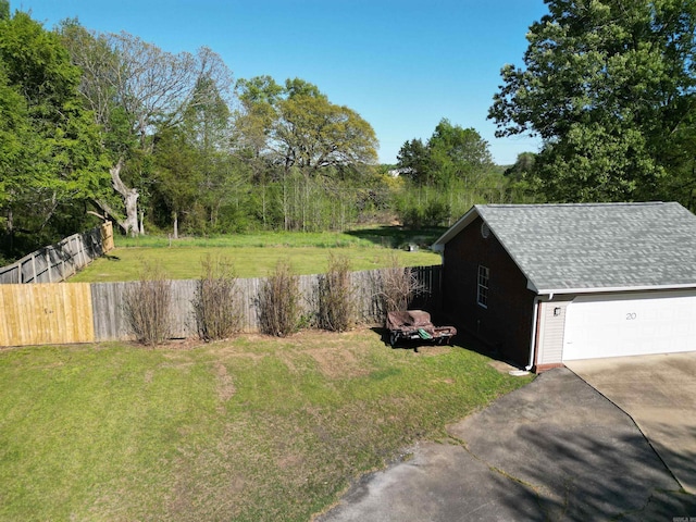 view of yard featuring fence and a detached garage