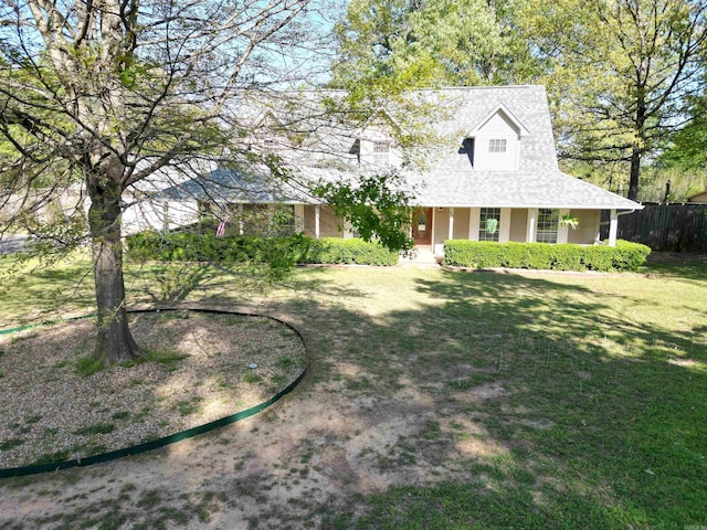farmhouse with a front yard and fence