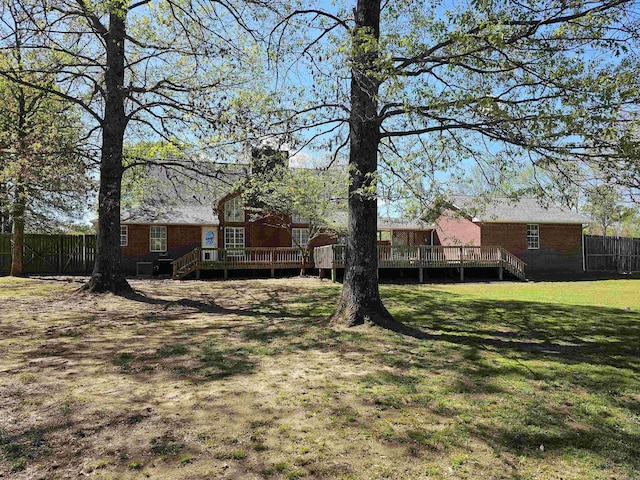 view of yard featuring a deck and fence