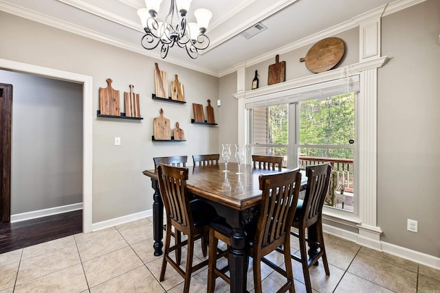 dining space featuring light tile patterned floors, baseboards, an inviting chandelier, and ornamental molding