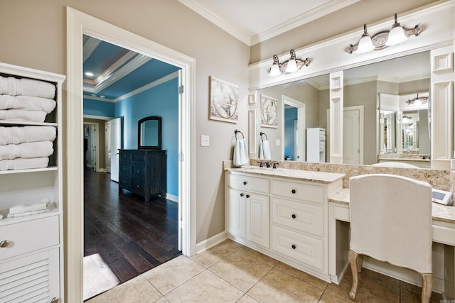 bathroom with ornamental molding, baseboards, vanity, and tile patterned floors