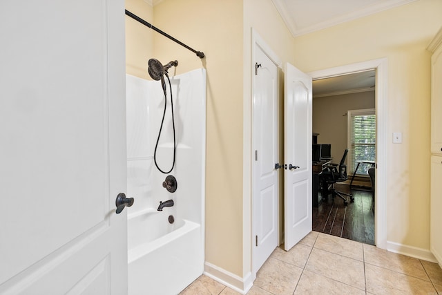 bathroom featuring crown molding, tile patterned floors, bathing tub / shower combination, and baseboards