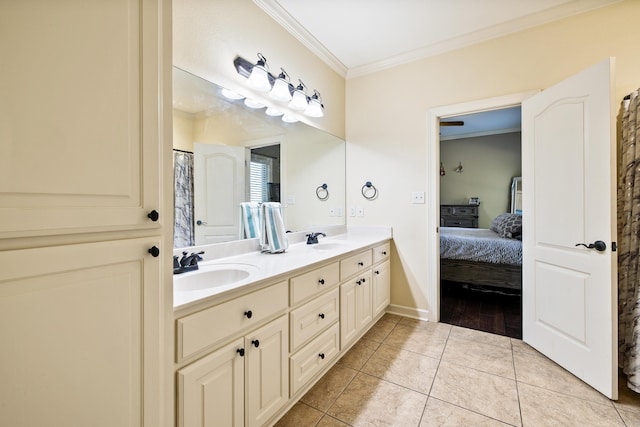 ensuite bathroom with crown molding, double vanity, a sink, and tile patterned floors