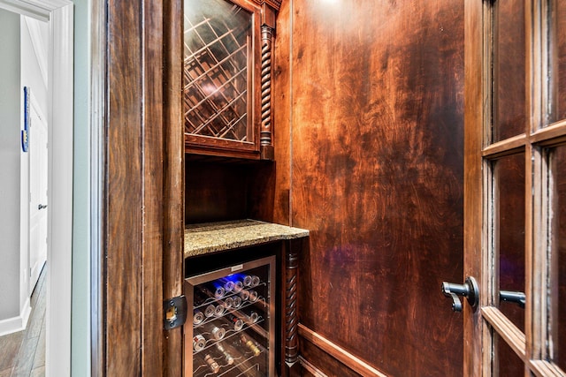 wine cellar with wine cooler and baseboards