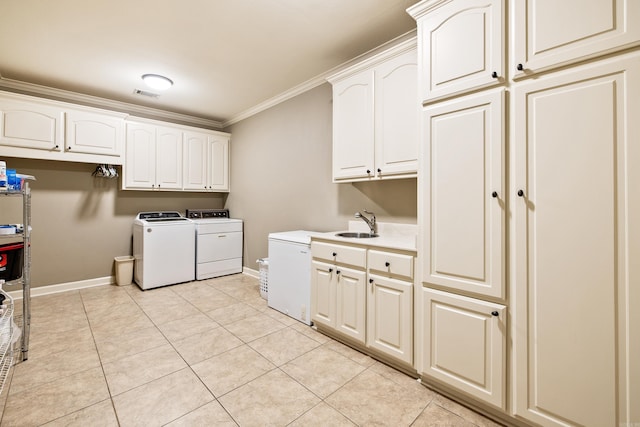 laundry area with cabinet space, baseboards, separate washer and dryer, and crown molding