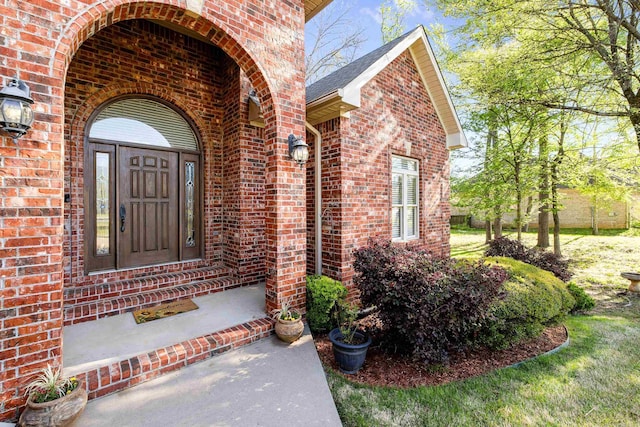 property entrance featuring brick siding