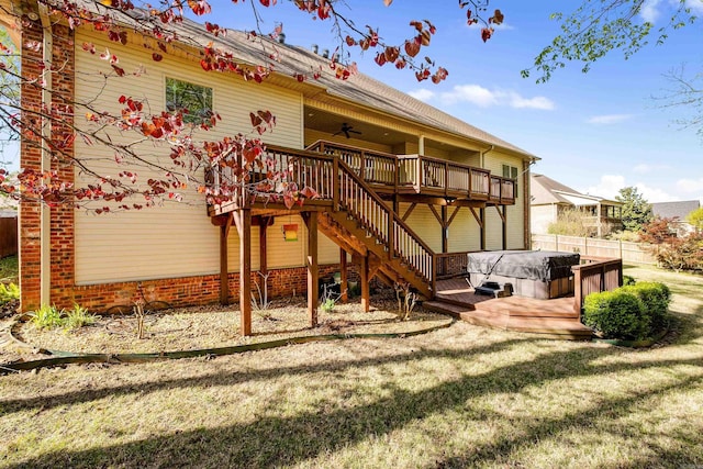 back of house featuring a wooden deck, ceiling fan, fence, and a hot tub