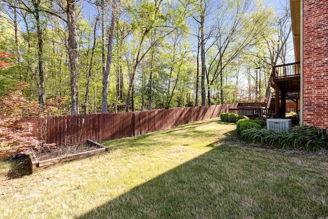 view of yard featuring central air condition unit, fence, and stairway