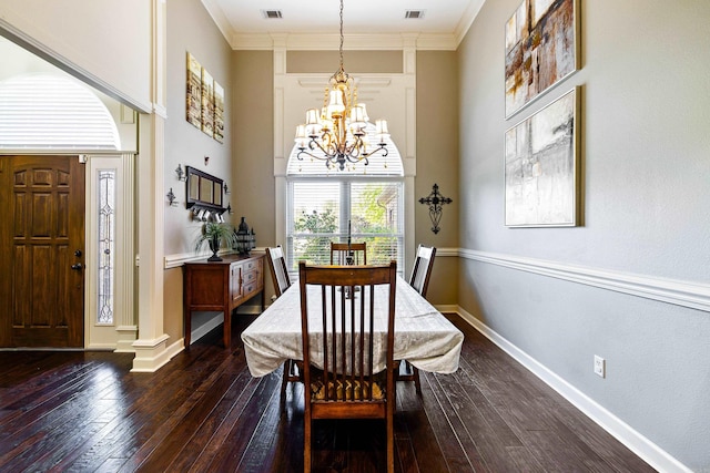 dining space featuring dark wood-style flooring, visible vents, and an inviting chandelier