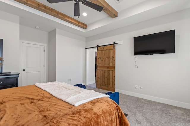 bedroom with visible vents, baseboards, a barn door, beam ceiling, and carpet flooring