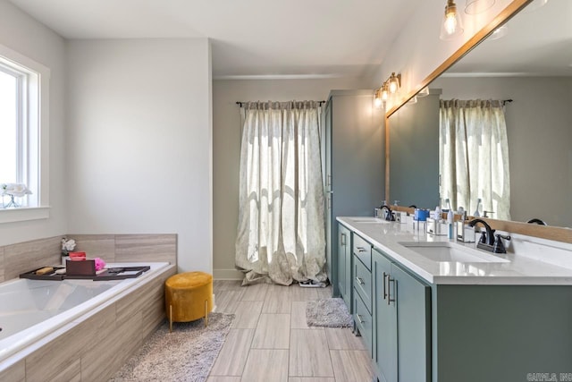 full bathroom featuring double vanity, a bath, and a sink