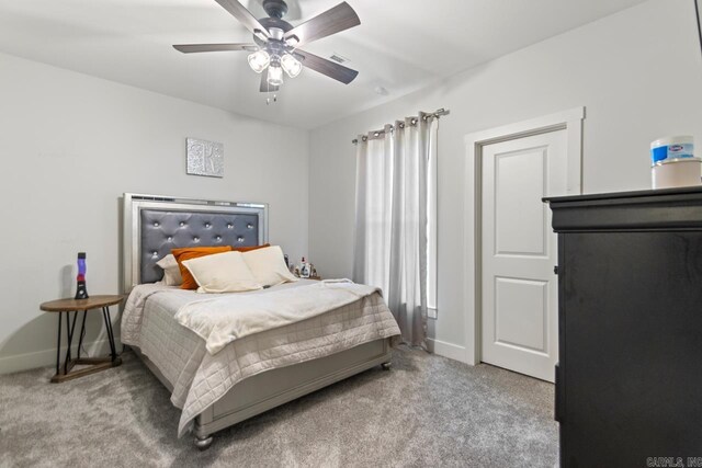 bedroom featuring baseboards, ceiling fan, and carpet