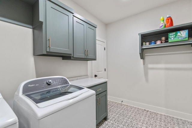 laundry area featuring baseboards, washing machine and clothes dryer, light floors, and cabinet space