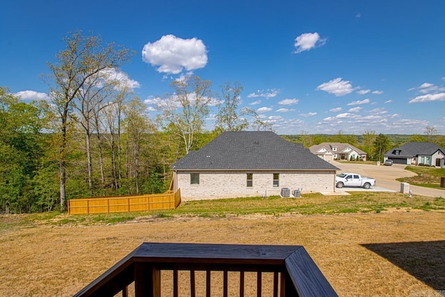 view of yard featuring central air condition unit and fence