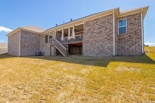 rear view of house with stairs, brick siding, cooling unit, and a ceiling fan