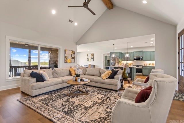 living room featuring visible vents, dark wood-style flooring, ceiling fan, beamed ceiling, and high vaulted ceiling