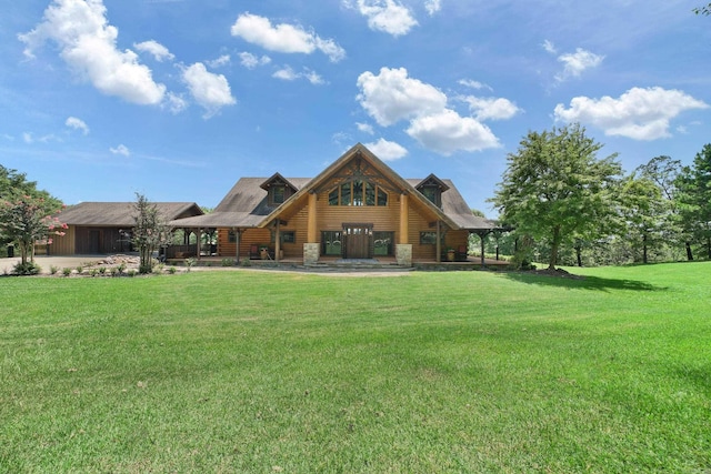rear view of house featuring stone siding and a lawn