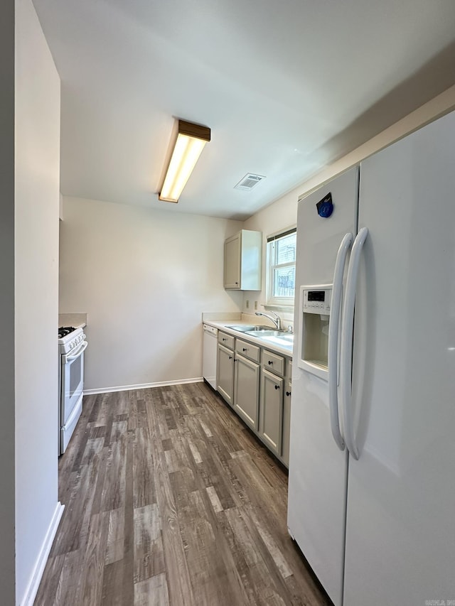 3 Park Ridge Dr, Maumelle, AR 72113 - kitchen with white appliances, a sink, dark wood-style flooring, light countertops, and baseboards