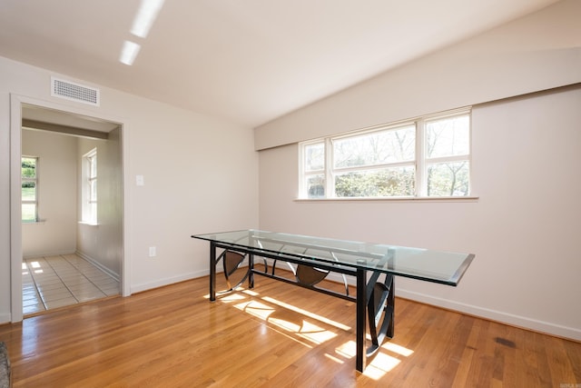 game room featuring light wood-style floors, visible vents, baseboards, and vaulted ceiling