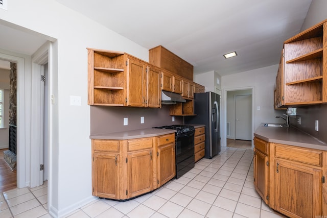 kitchen with open shelves, stainless steel refrigerator with ice dispenser, under cabinet range hood, light tile patterned flooring, and black gas range