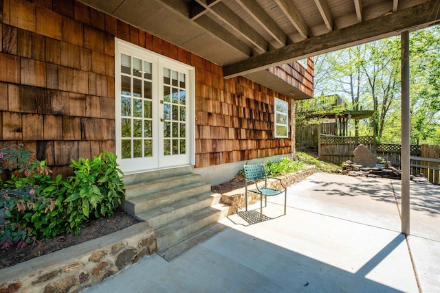 view of patio featuring entry steps, french doors, and fence