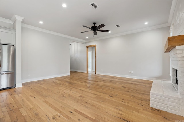 unfurnished living room featuring visible vents, ceiling fan, light wood-style floors, and a fireplace