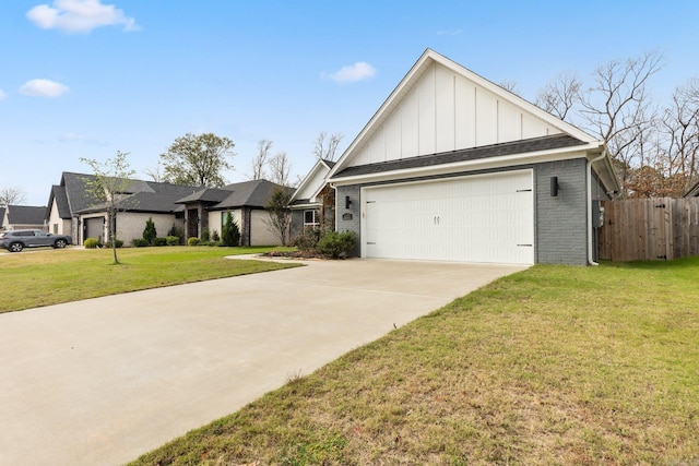view of front of house featuring board and batten siding, fence, brick siding, a front lawn, and driveway