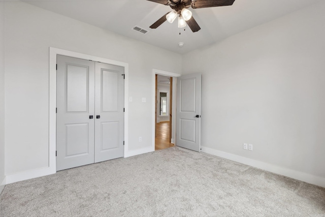 unfurnished bedroom with a closet, baseboards, carpet, and visible vents
