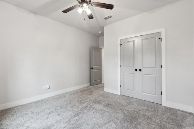 unfurnished bedroom featuring ceiling fan, carpet, a closet, visible vents, and baseboards