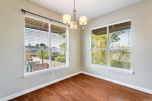 820 N St, Little Rock, AR 72201 - spare room with a notable chandelier, baseboards, and wood finished floors