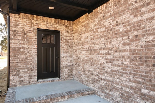 entrance to property with brick siding