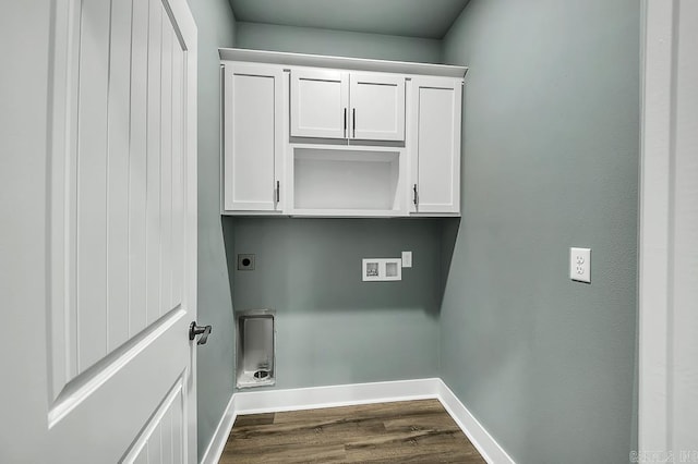 laundry area featuring baseboards, dark wood-style floors, cabinet space, electric dryer hookup, and hookup for a washing machine