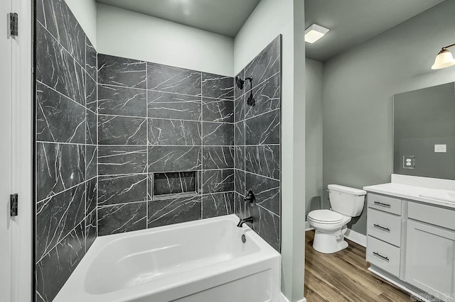 full bathroom featuring bathing tub / shower combination, wood finished floors, vanity, and toilet