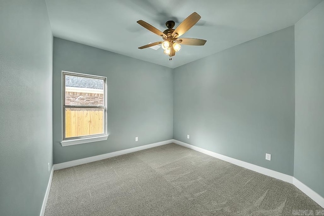 spare room featuring carpet flooring, baseboards, and a ceiling fan