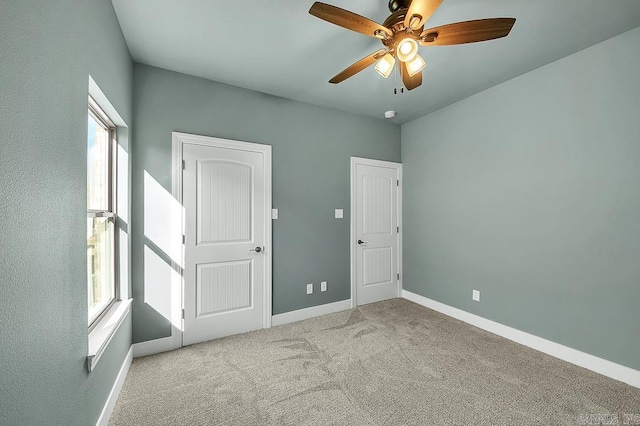 unfurnished bedroom with baseboards, a ceiling fan, and carpet floors