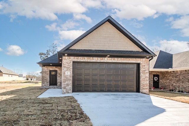 view of front facade featuring brick siding, roof with shingles, an attached garage, and concrete driveway