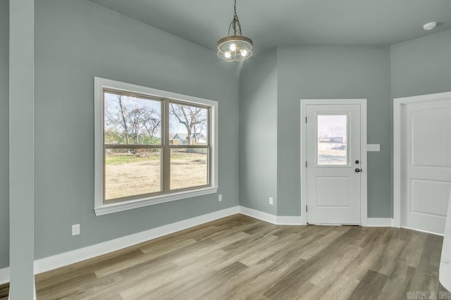 interior space with baseboards and wood finished floors