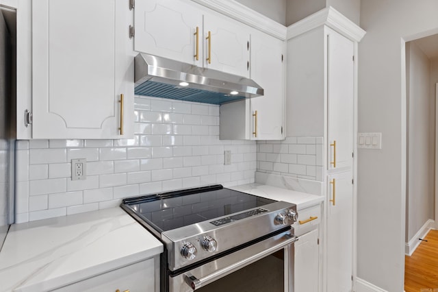 6723 Greenwood, Little Rock, AR 72207 - kitchen featuring electric stove, decorative backsplash, under cabinet range hood, and white cabinets