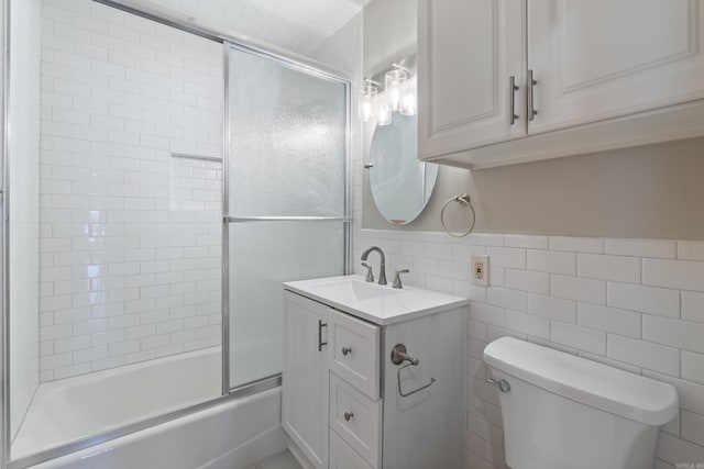 6723 Greenwood, Little Rock, AR 72207 - bathroom featuring toilet, tile walls, bath / shower combo with glass door, and vanity