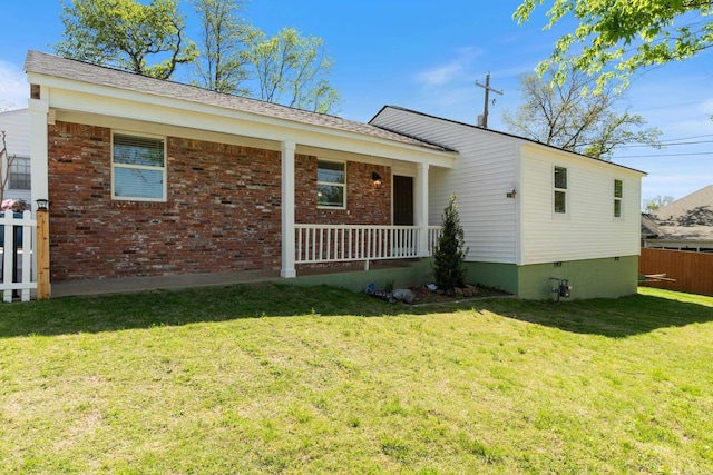 6723 Greenwood, Little Rock, AR 72207 - view of front facade featuring brick siding, fence, covered porch, and a front yard
