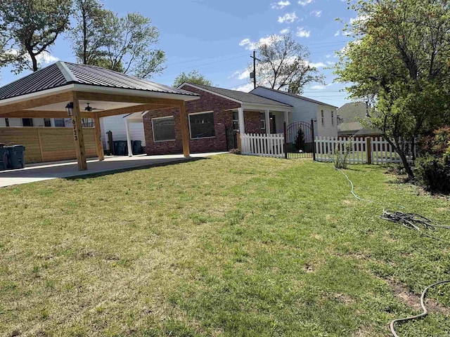 6723 Greenwood, Little Rock, AR 72207 - exterior space featuring fence, brick siding, metal roof, a gazebo, and a yard