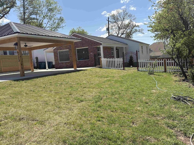 6723 Greenwood, Little Rock, AR 72207 - rear view of house featuring a ceiling fan, metal roof, brick siding, fence, and a yard