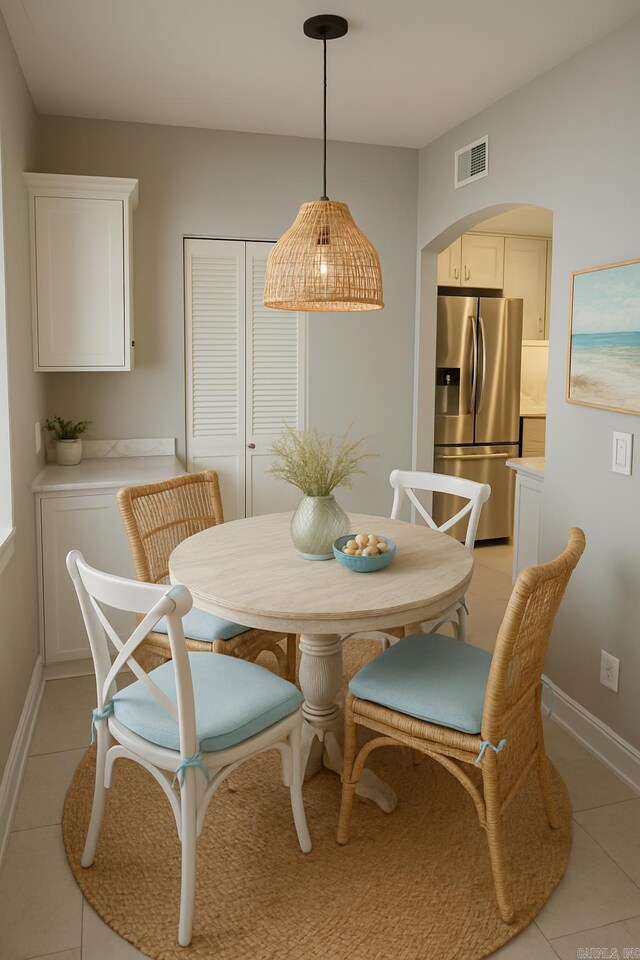 6723 Greenwood, Little Rock, AR 72207 - dining room featuring arched walkways, baseboards, light tile patterned flooring, and visible vents