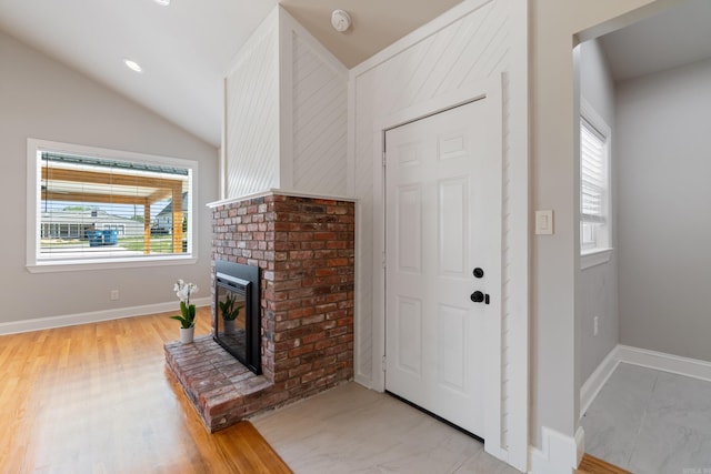 6723 Greenwood, Little Rock, AR 72207 - foyer with baseboards, vaulted ceiling, light wood-style flooring, and a fireplace